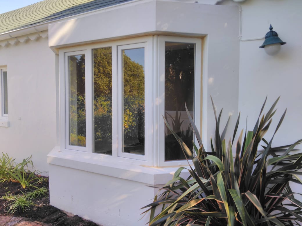 WHITE UPVC SIDE HUNG DOUBLE GLAZED WINDOWS WITH FIXED PANEL WINDOW IN THE CENTRE AND ON THE SIDES